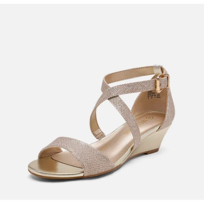 A pair of gold-toned, strappy wedge sandals.