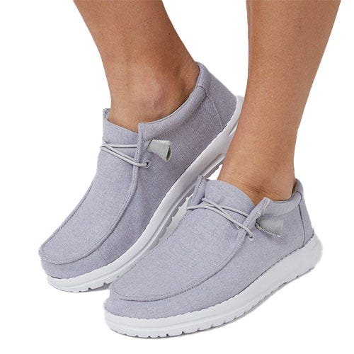 Gray casual slip-on shoes with white soles and decorative laces, designed for comfort and easy wear.