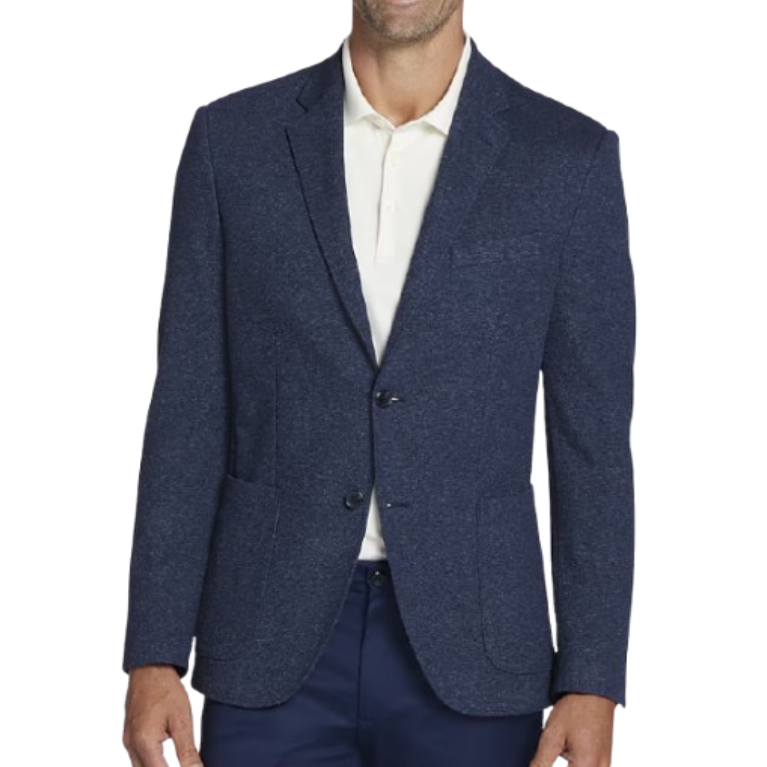 A man wearing a navy blazer over a white shirt, paired with dark pants.
