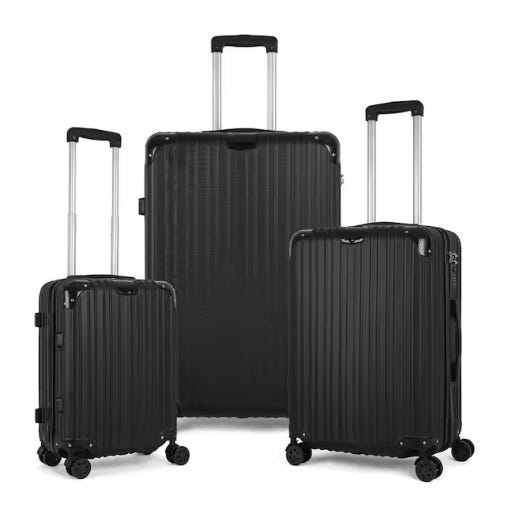 Three black rolling suitcases of varying sizes with extendable handles and four-wheel bases.