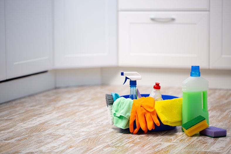 basket of cleaning products on floor
