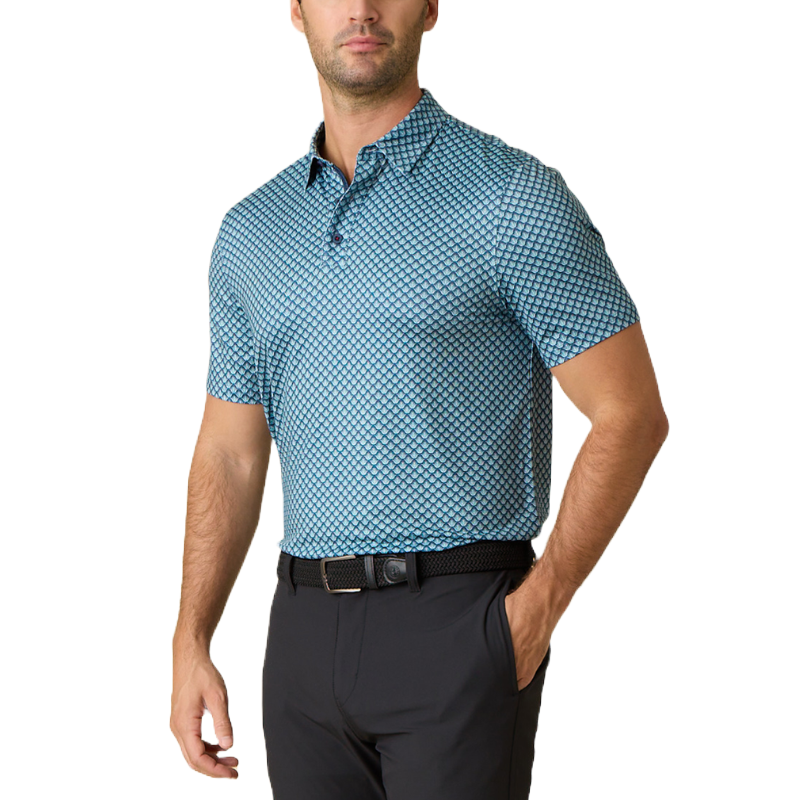 A man wears a blue polo shirt featuring a small repeating geometric pattern paired with black pants. The shirt has short sleeves and a buttoned collar.