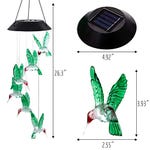 A solar LED hummingbird wind chime features multiple hanging hummingbird figures that light up, powered by a solar panel on top. Dimensions: Bird width 2.55 inches, height 3.93 inches; top width 4.92 inches, total length 26.3 inches.