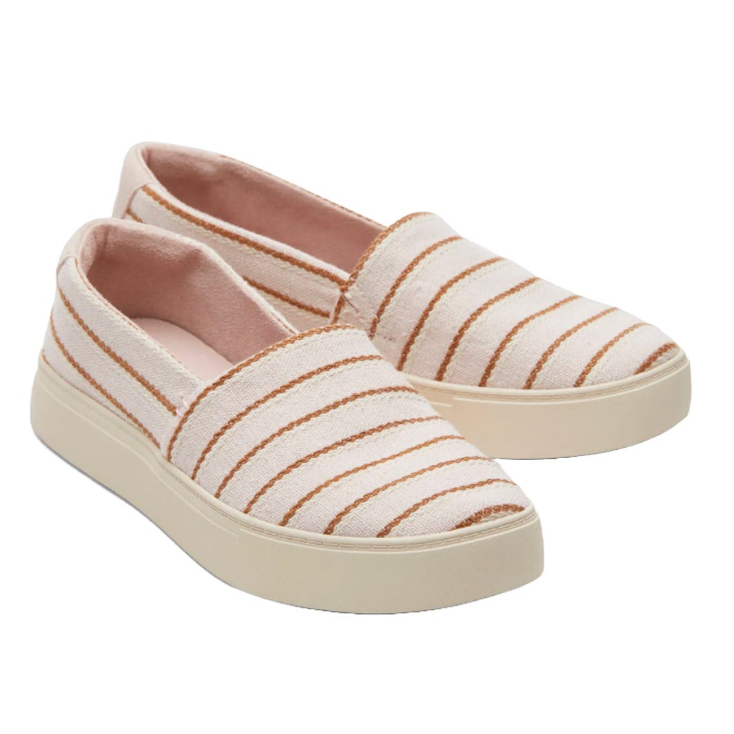 TOMS Women's Sneakers featuring cream-colored fabric with horizontal brown stripes and a slip-on design, complemented by white rubber soles for a casual look.