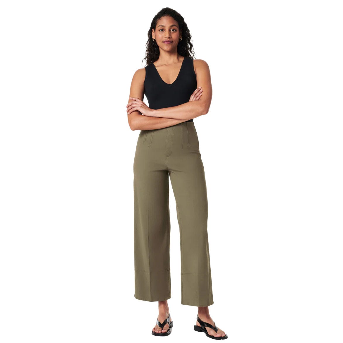 Olive-colored, high-waisted, cropped wide-leg pants paired with a black sleeveless top and black sandals.