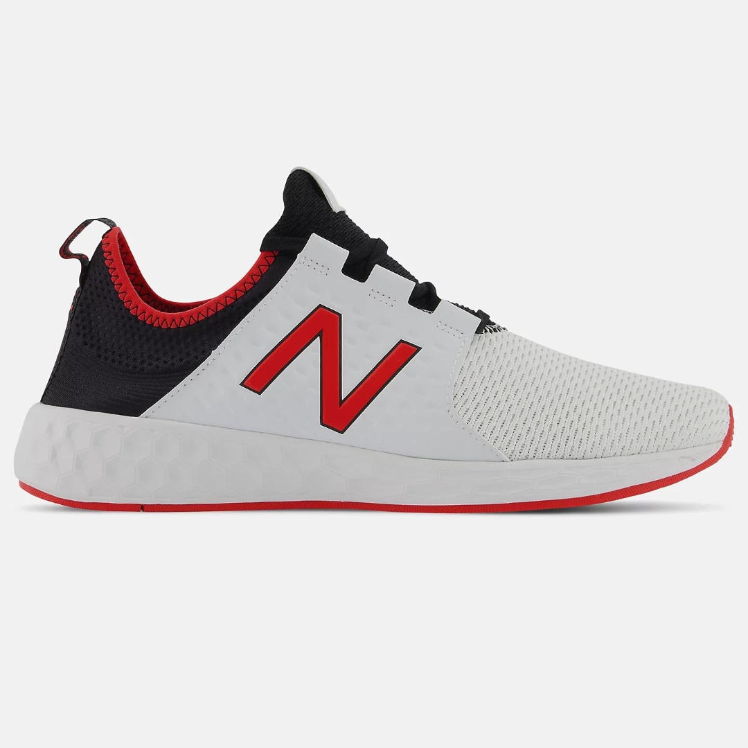 A side view of a New Balance running shoe with white mesh upper, black ankle support, a large red 'N' logo, and a red trim on the sole.