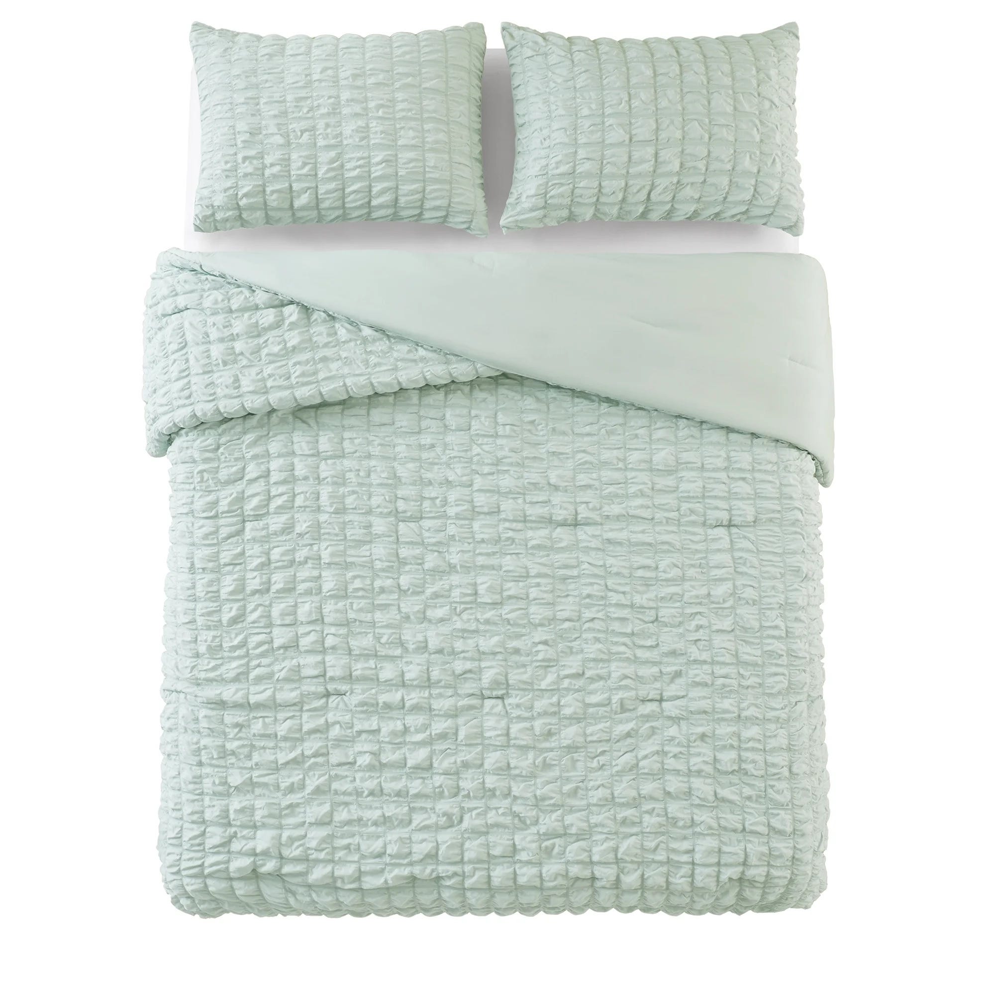 Light green quilted bedding set with a textured pattern, including a comforter and two matching pillows.
