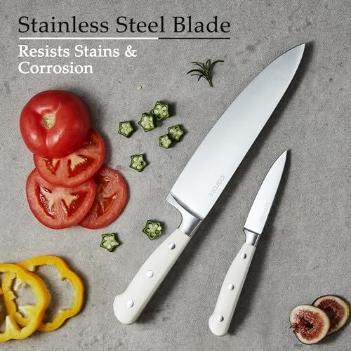 Two knives with stainless steel blades and white handles alongside sliced vegetables, highlighting their stain and corrosion resistance.