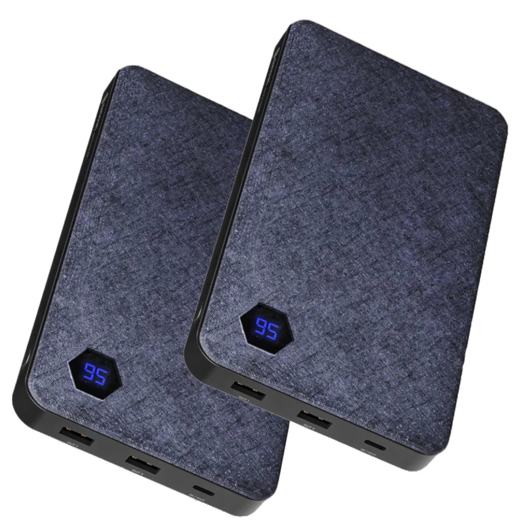 2pk Einova 20,000mAh Power Banks feature a dark fabric-like texture with a digital display showing remaining charge percentage. Equipped with multiple USB ports for device charging.