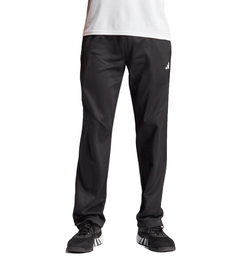 Black Adidas track pants with a subtle logo on the thigh, paired with black Adidas sneakers.