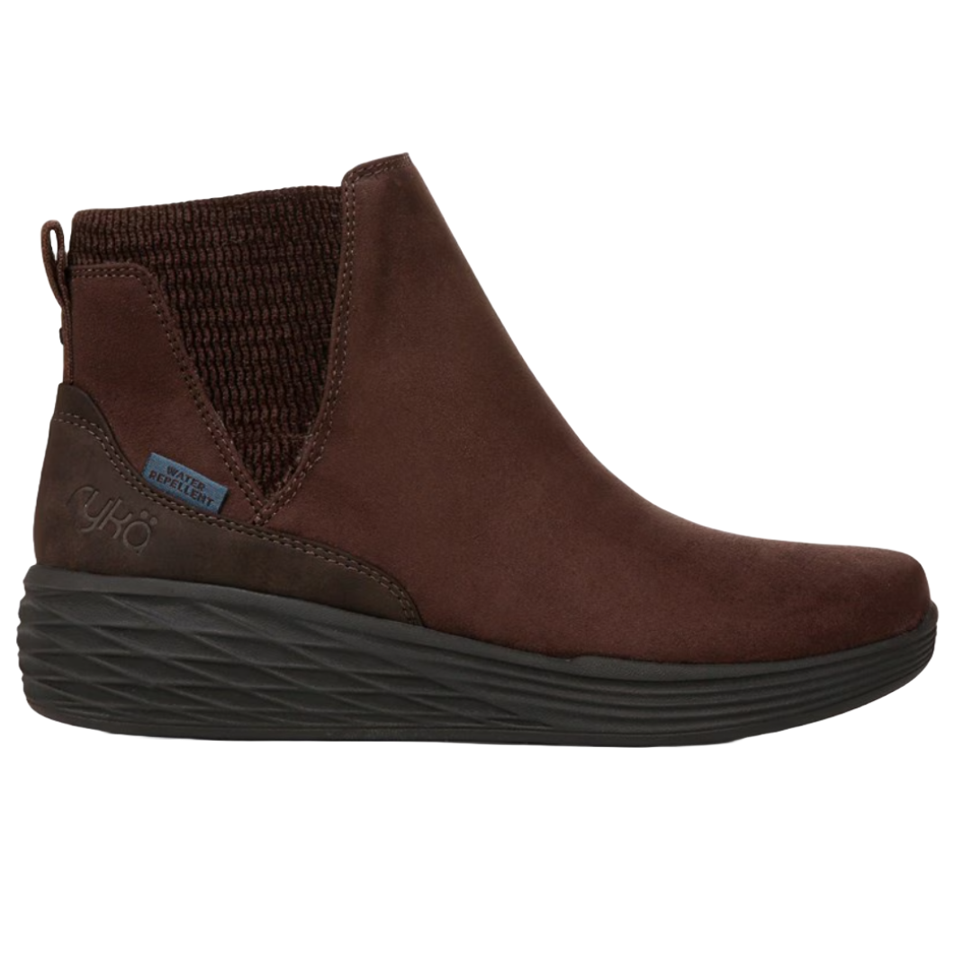 The Ryka Noelle Booties are brown, water-repellent ankle boots with elastic side panels, a pull tab at the back, and a textured black sole for better grip.