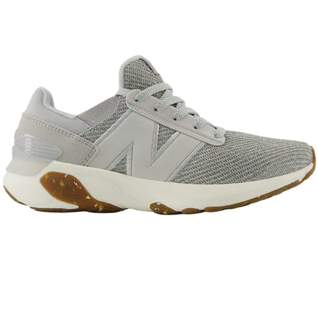 A gray New Balance sneaker with a mesh upper, large \“N\“ logo on the side, and a white midsole featuring orange-brown accents.
