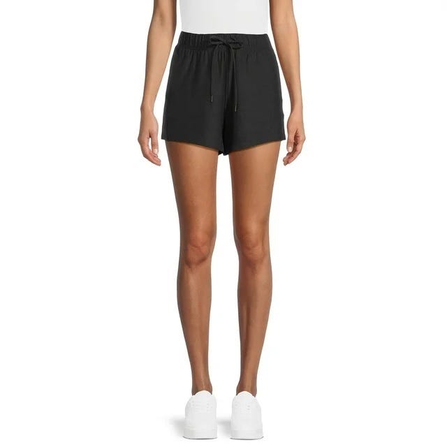 Black drawstring shorts and white sneakers.