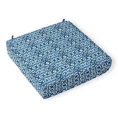 Blue and white geometric patterned deep-seat cushion with tie-downs at the corners.
