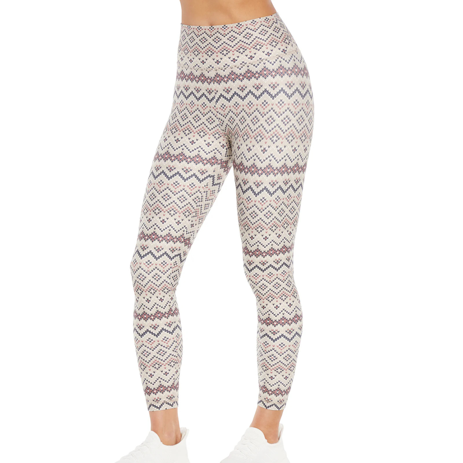 High-waisted ankle leggings with a geometric pattern in cream, blue, and maroon tones, paired with white sneakers.