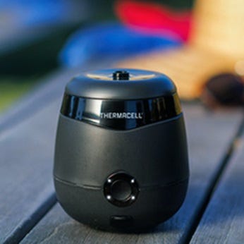 A black Thermacell mosquito repellent device on a wooden surface.