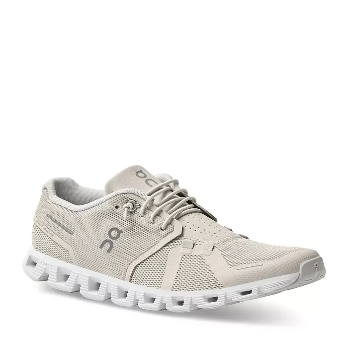 A single beige sports shoe with laces and a white sole.