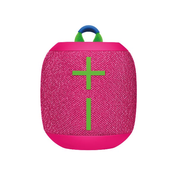 The Wonderboom 3 Speaker is a portable Bluetooth speaker in pink with a woven texture, featuring prominent green plus and minus symbols for volume control. It includes a blue and green loop handle for easy carrying.
