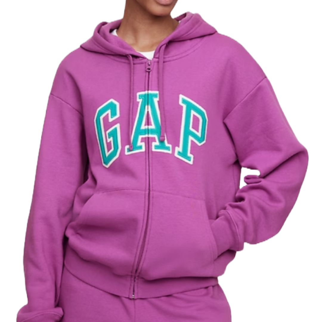 A person wearing a purple GAP hoodie with a front zipper and white and teal lettering.