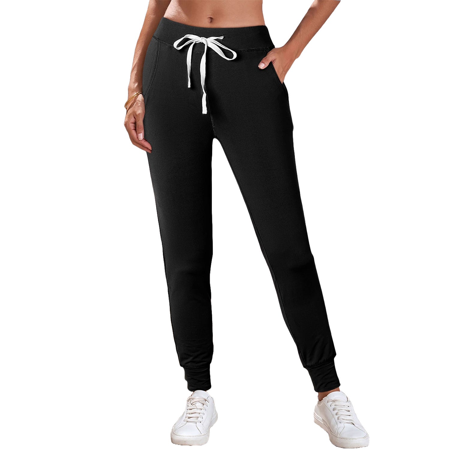 A pair of black drawstring leggings featuring side pockets and cuffed ankles, paired with white sneakers.