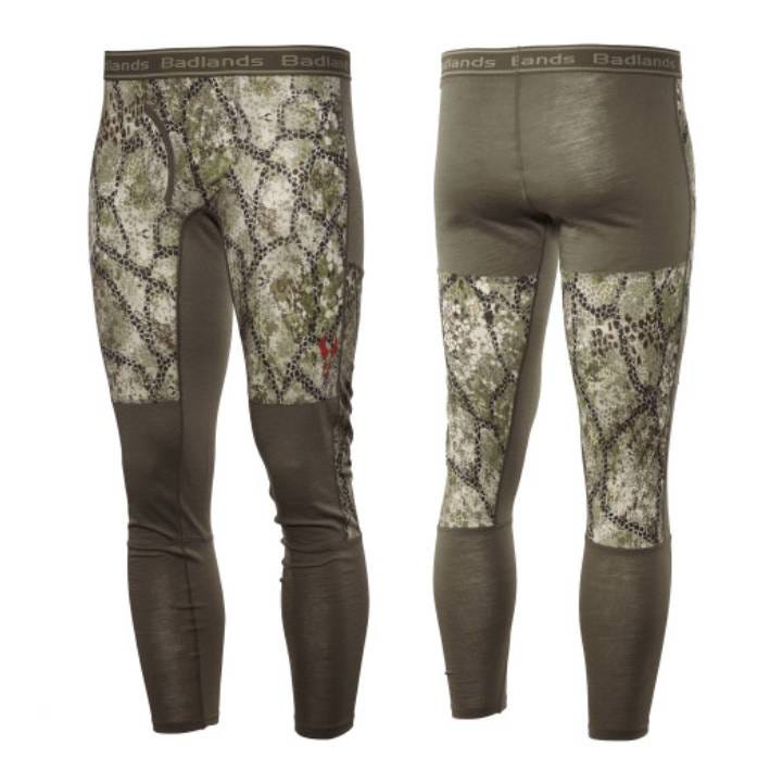The pants feature a camouflage pattern with green and brown tones, an elastic waistband with \“Badlands\“ branding, and are designed as a form-fitting base layer for outdoor activities.