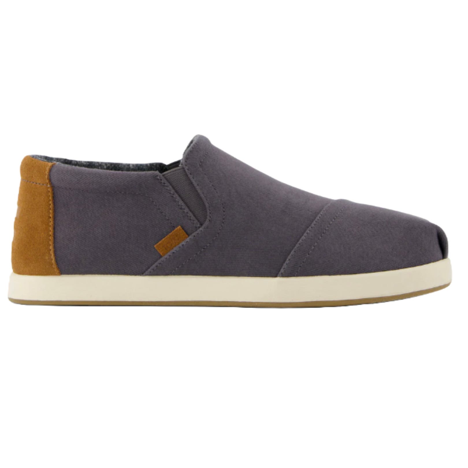 TOMS Men's Slip-On Sneakers feature a minimalist design with a dark gray upper, brown heel accent, and a cream-colored rubber sole.
