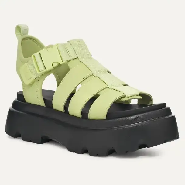 Lime green strappy sandals with a chunky black sole.