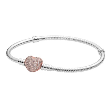 A silver bracelet with a snake chain design featuring a rose gold heart-shaped clasp adorned with small crystals.