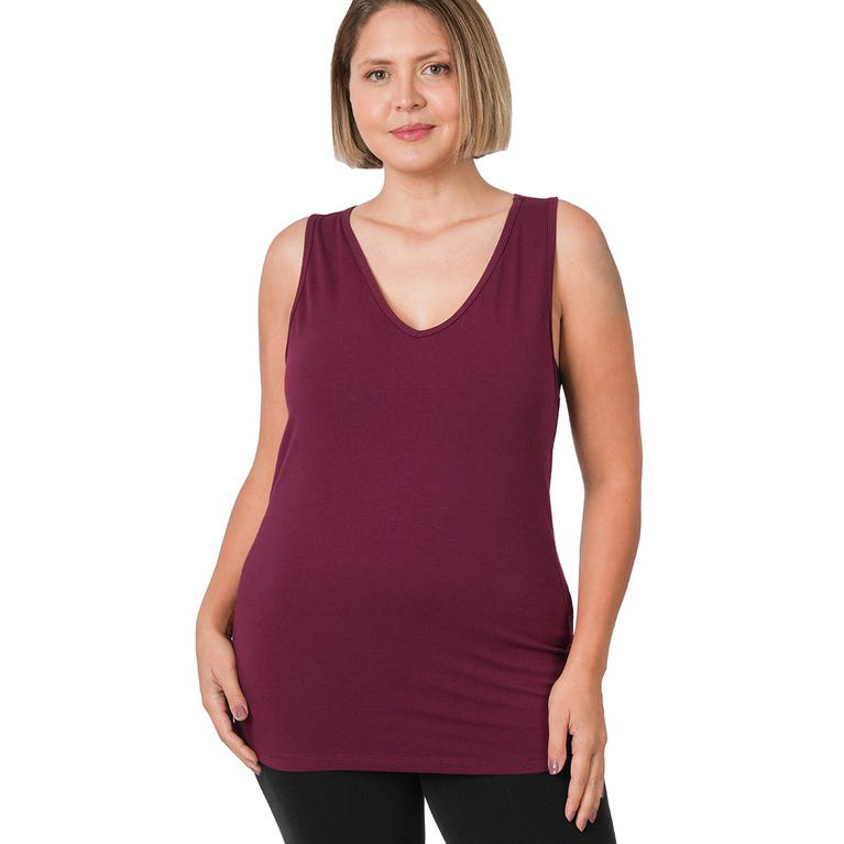 A woman wearing a maroon sleeveless V-neck top and black leggings.