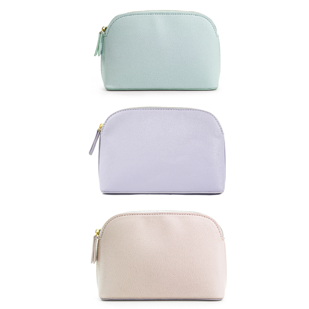 Three cosmetic pouches in pastel blue, lavender, and beige, stacked vertically.