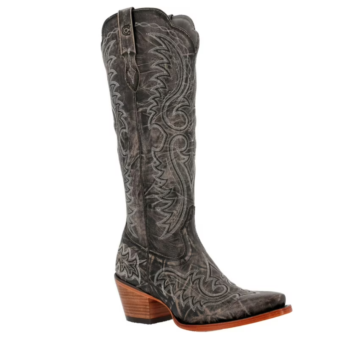 Durango Crush Tall Western Boots feature a distressed black leather finish with intricate white stitching and embroidery. They have a tall shaft, pull tabs, a square toe, and a stacked wooden heel, offering a classic Western style.