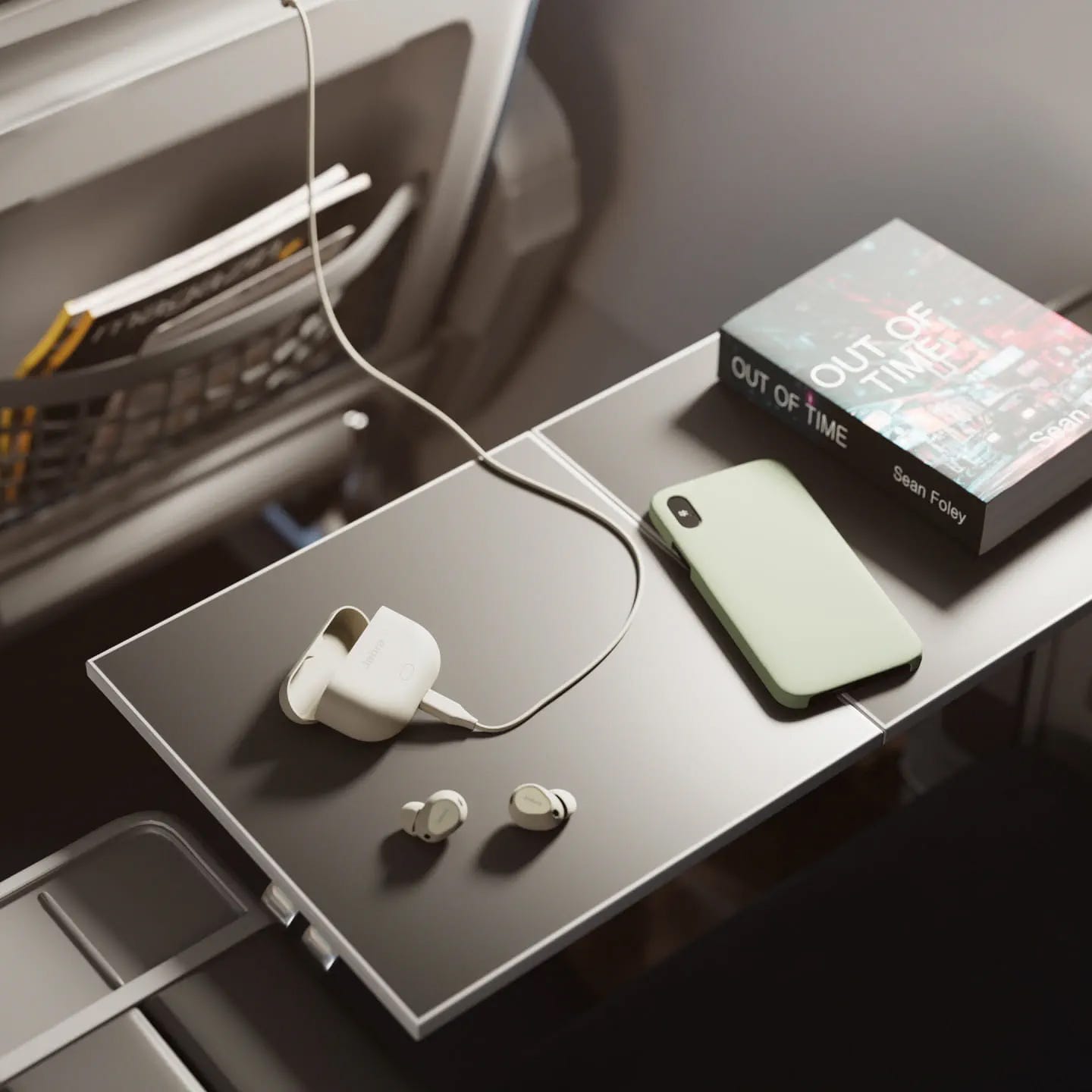 Earbuds connected to a charging case and a smartphone with a green case are situated on an airplane tray table next to a book.