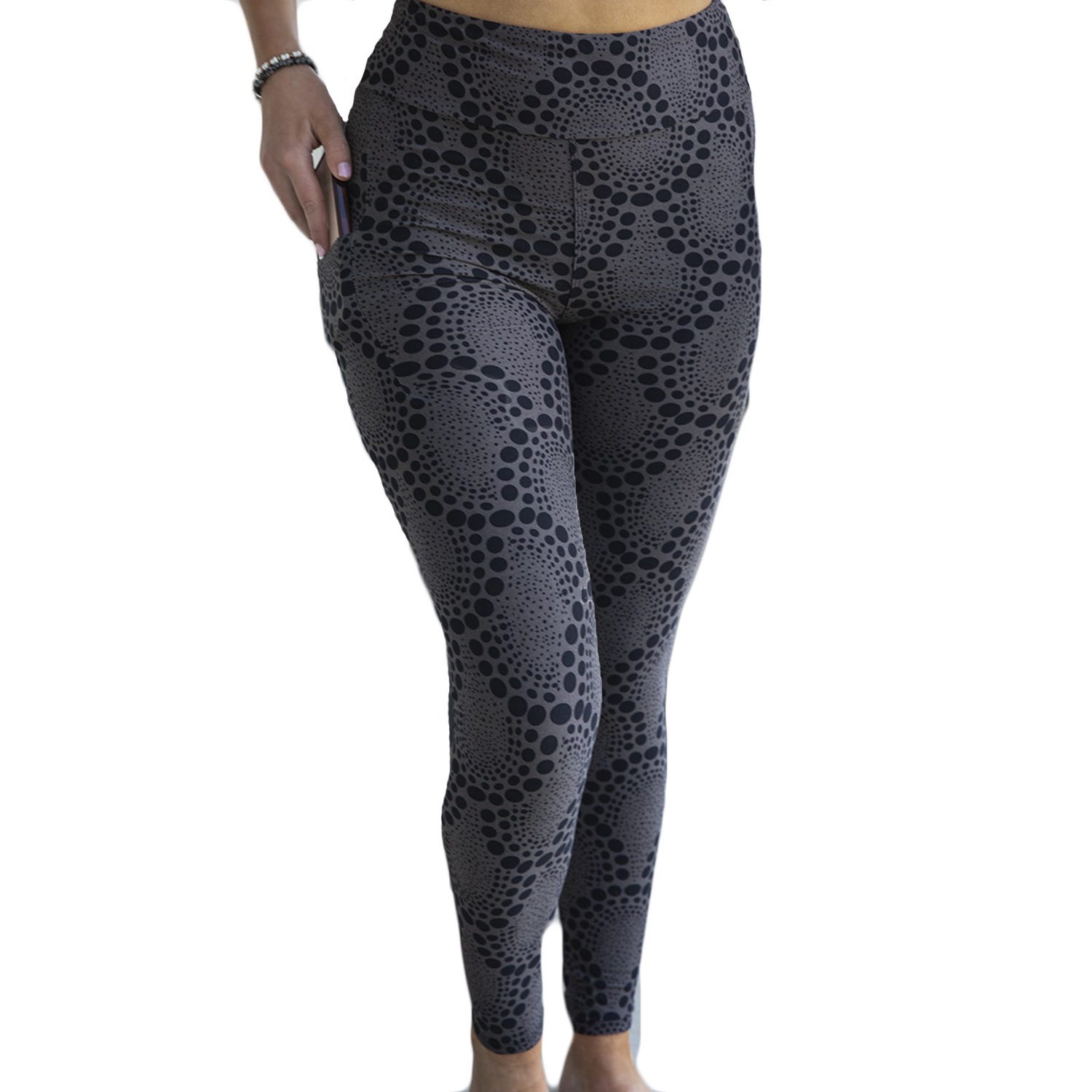 A person wearing black and gray patterned leggings.