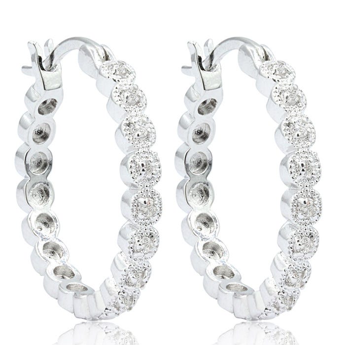 Silver hoop earrings embellished with round, sparkling stones.