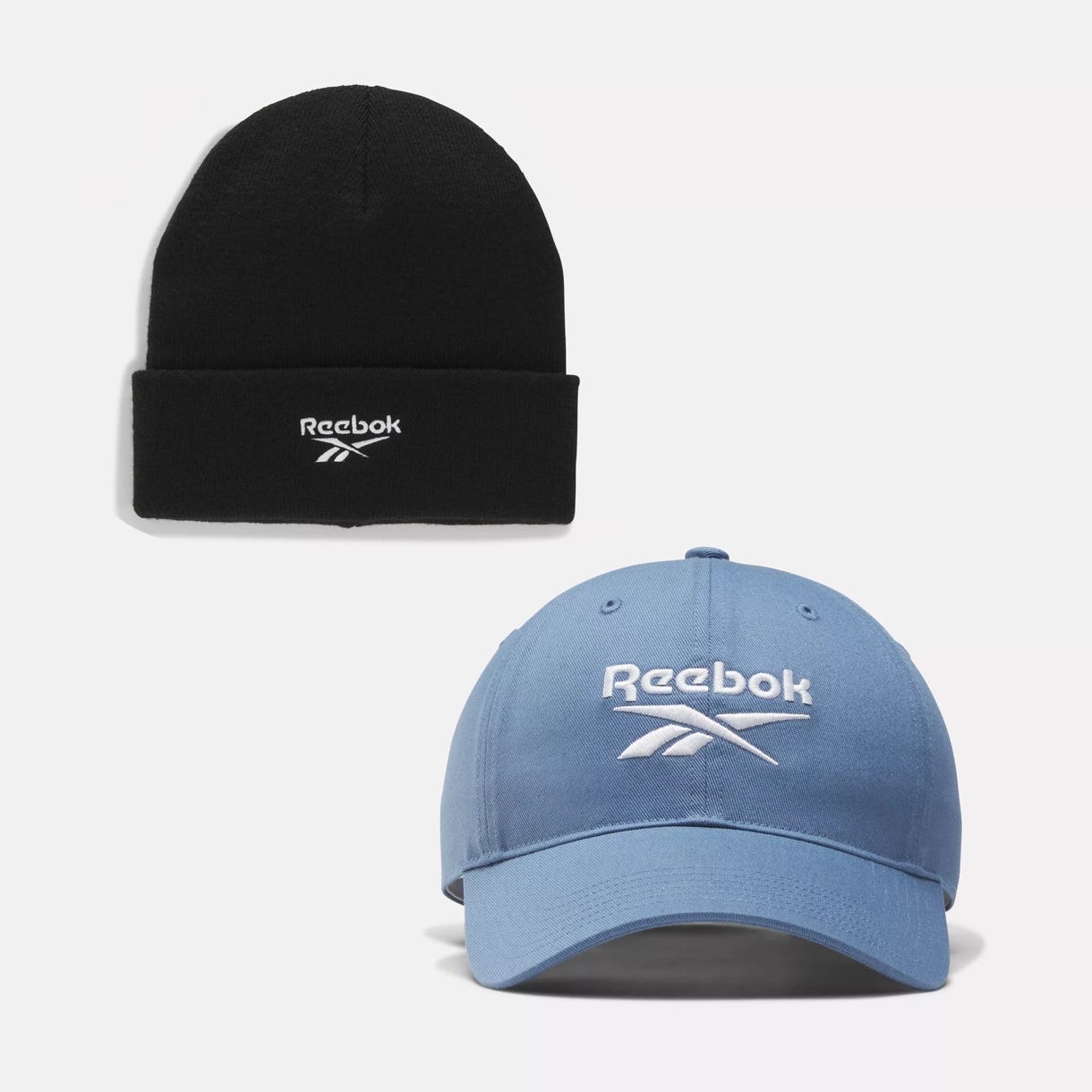 A black beanie and a light blue baseball cap, both with the Reebok logo.