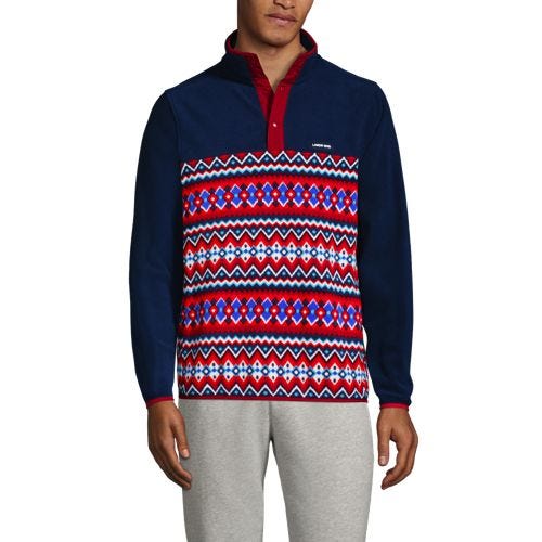 A man is wearing a Lands' End fleece pullover with a half-zip design, featuring a patterned chest in red, white, and blue, and a solid navy color on the arms and back.