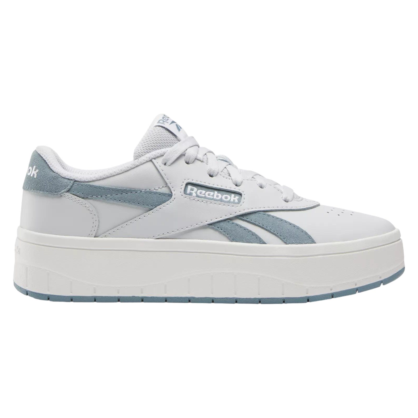 A white and blue Reebok sneaker with a thick platform sole and lace-up design.