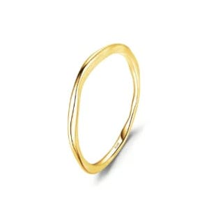 A thin, gold-colored ring with a subtle wavy design, reflecting a minimalist style.