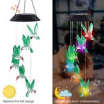 A solar LED hummingbird wind chime with a black top panel; during the day, it charges, and at night, it illuminates the colorful acrylic hummingbirds for over 8 hours.