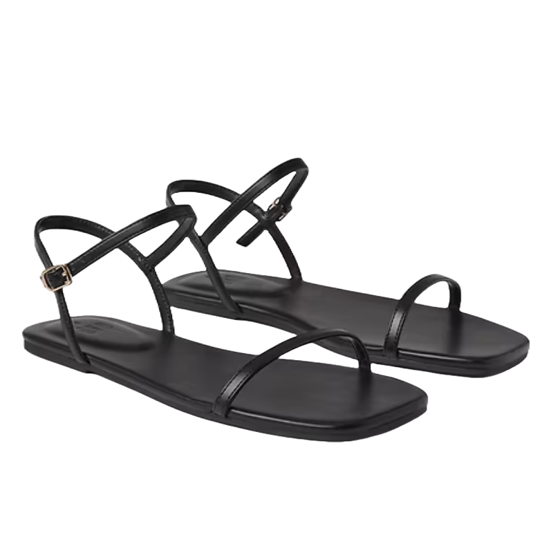 Black strappy flat sandals with thin straps, including an adjustable ankle strap and toe loop, featuring a minimalist design.