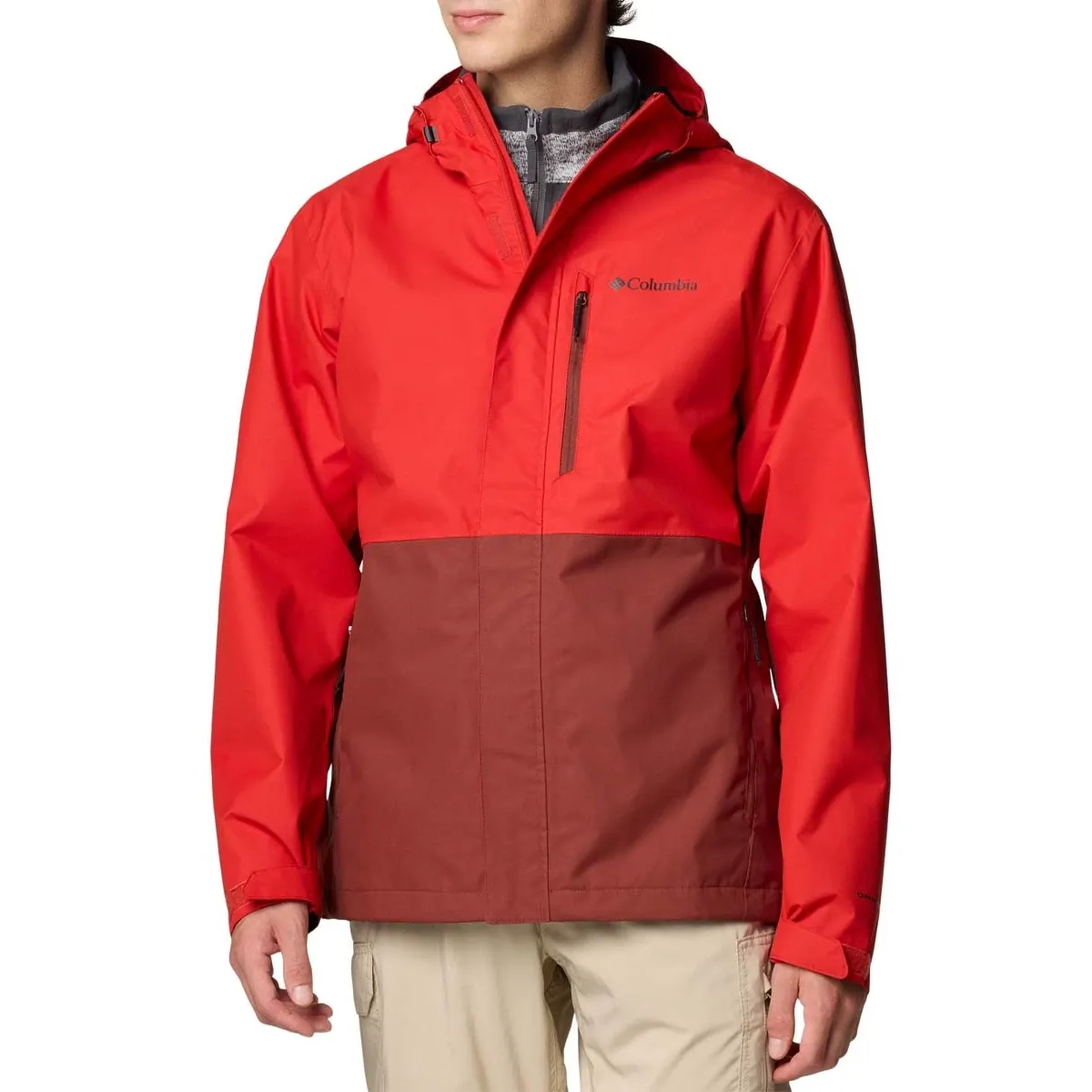 A two-tone red and brown Columbia jacket with a hood and a zippered chest pocket, worn over a gray inner layer.