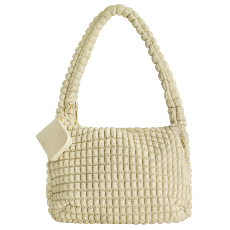 Cream-colored, textured handbag with a woven design, featuring a large handle and a small attached pouch.