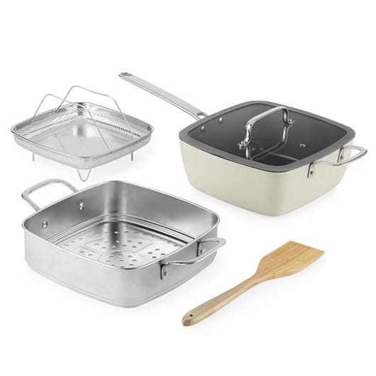 A cookware set featuring a square non-stick pan with a lid, a stainless-steel steamer insert, a frying basket, and a wooden spatula.