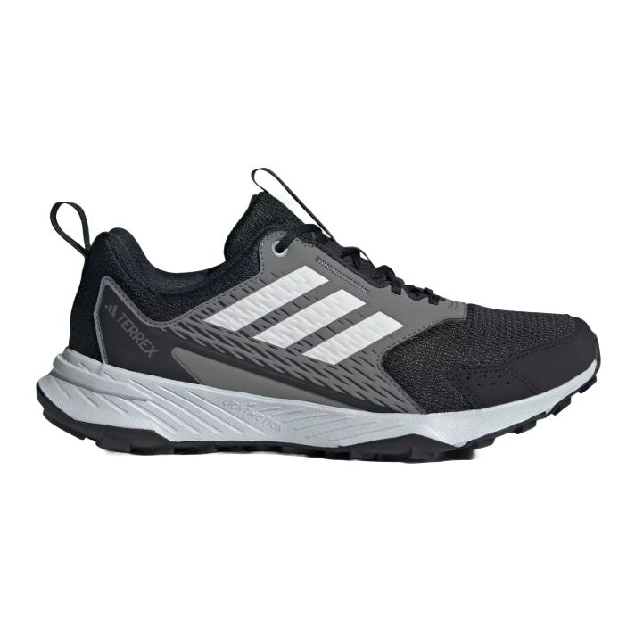 A black and gray Adidas Terrex trail running shoe featuring white stripes and a durable sole suitable for outdoor activities.