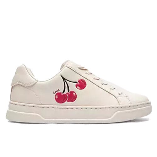 Cream-colored low-top sneakers with red cherry prints and black stems, featuring matching laces and a white sole.