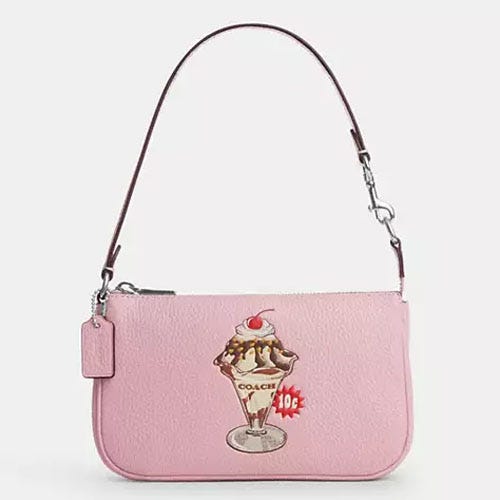 Pink shoulder bag with ice cream sundae graphic and brand logo.