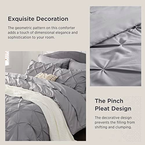 A 7-piece quilted comforter set featuring a geometric pinch pleat design, offering a sophisticated and decorative element to the bedroom decor.