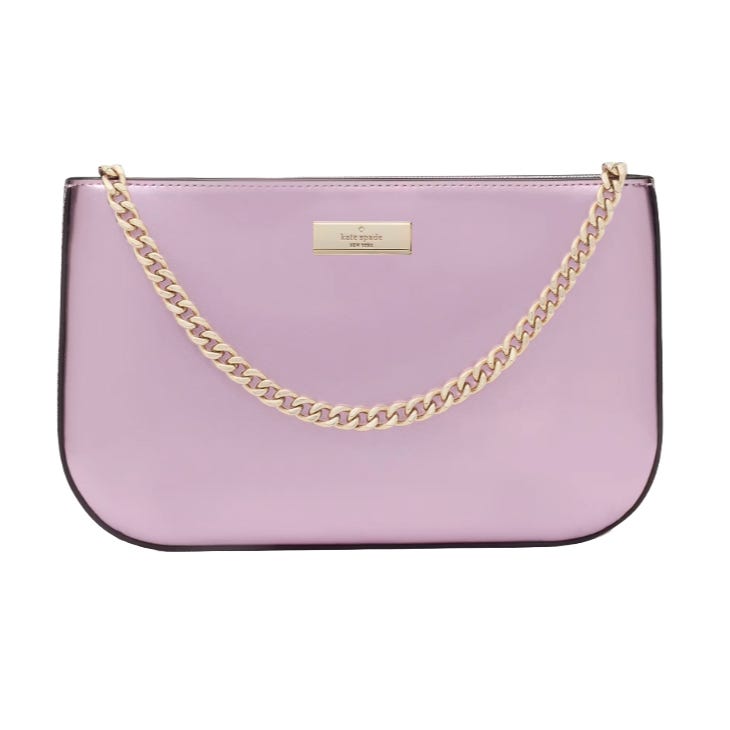 The Kate Spade Lilly Pochette is a sleek lilac bag with a smooth finish, featuring a gold-toned chain strap and a metal logo plate on the front.