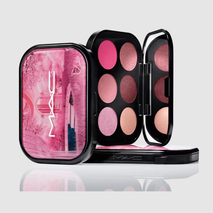 An eyeshadow palette with various shades of pink and beige, including matte and shimmer finishes, in a black compact with a decorative pink lid.