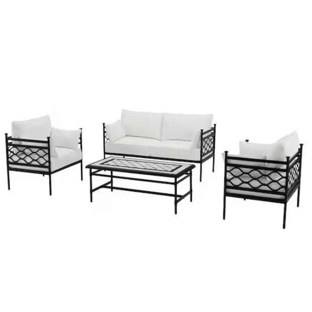 A four-piece outdoor furniture set with a sofa, two chairs, and a coffee table, all featuring black frames and white cushions.